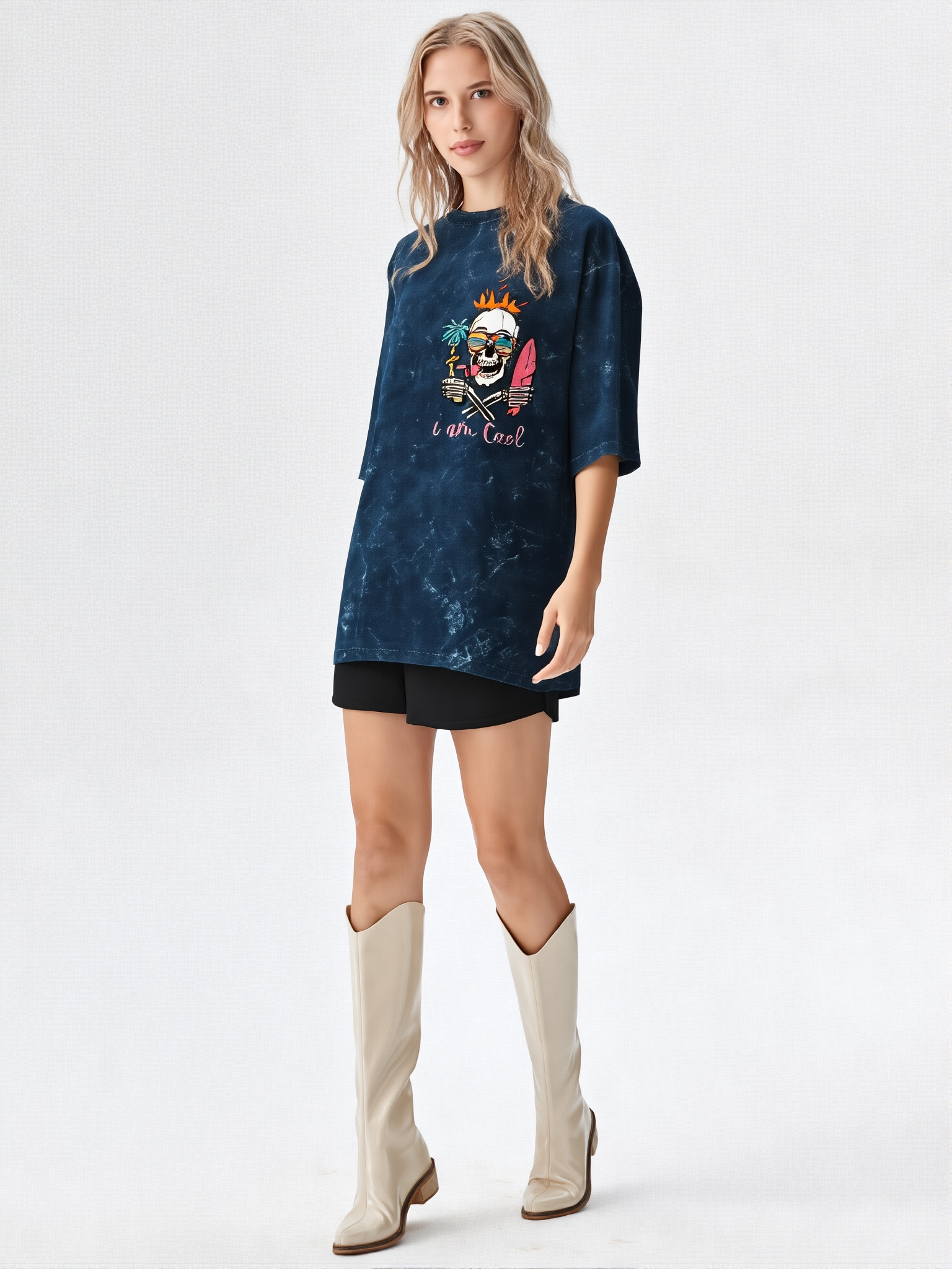 Woman wearing a blue oversized t-shirt with a graphic design and beige knee-high boots on a white background